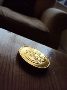 gold coin on wooden table