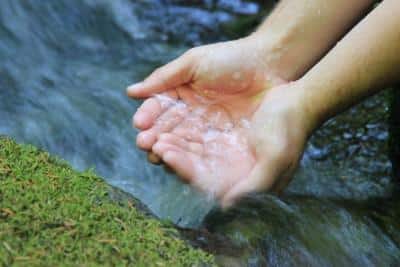 Hands cupping fresh water