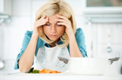 Depressed woman tired of preparing meals.