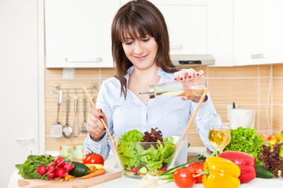 woman making salad paleo diet