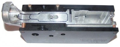 AR-15 Lower receiver casting in the template, with the top plate removed. The outlined area is what has to be cut out for the trigger group pocket. The two visible holes in the cutout are for the trigger. In addition, there are three holes in the sides of the template, which need to be drilled out. 